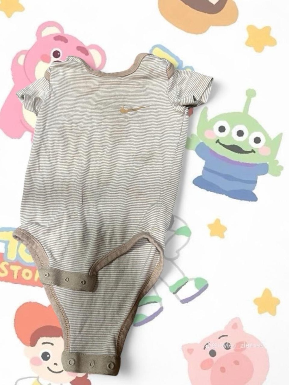 Nike Toddler Striped One-Piece Bodysuit in Beige and White
